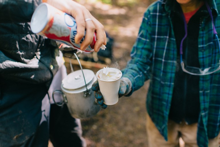 WTA volunteers top their hot chocolate with a swirl of whipped cream.