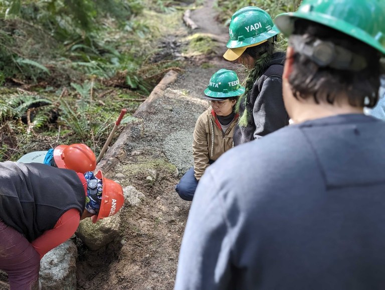 The 2024 Emerging Leaders Program cohort learns how to do rock work at Deception Pass State Park. Photo by Tiffany Chou.