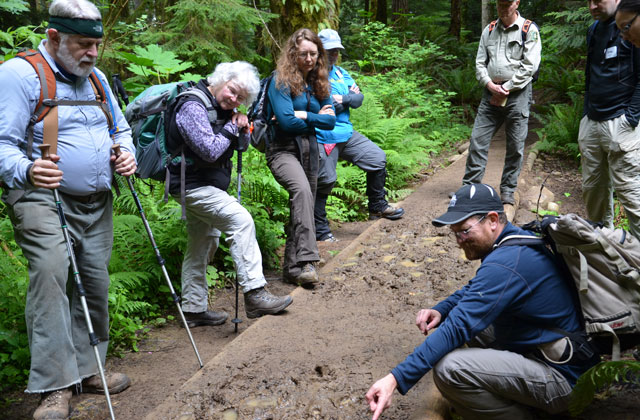 New ACLs and Forest Service evaluate a muddy turnpike with Tim Van Beek. Photo by Anna Roth. 