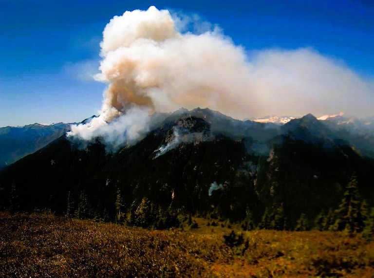 Smoke from the Miner's Complex Fire coming from the mountains in the Glacier Peak Wilderness. Photo courtesy of Mt. Baker-Snoqualmie National Forest Service.