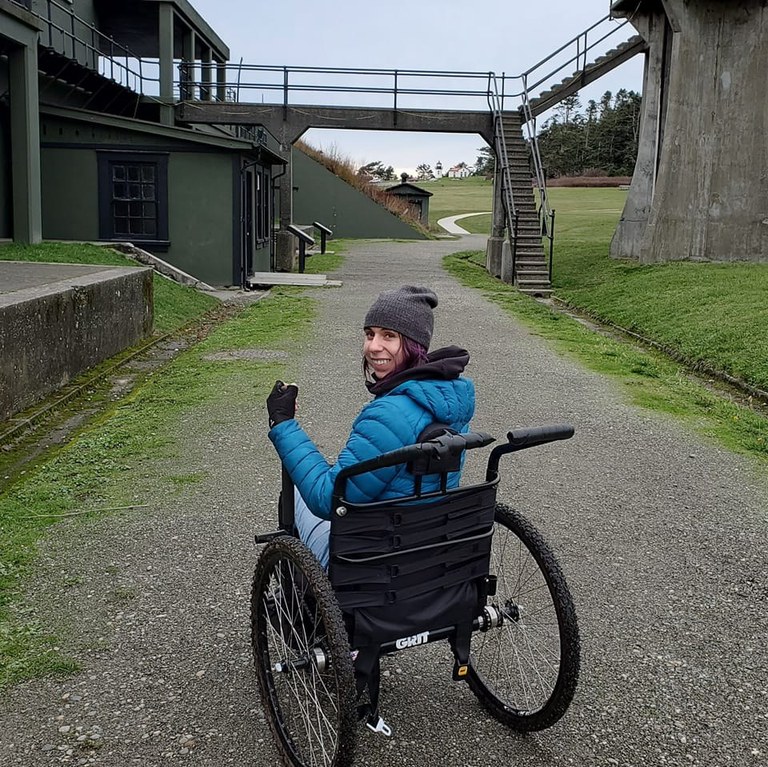 hiker in manual wheechair on wide gravel path at Fort Casey. Photo by thedirtbaguette. hiker in manual wheechair on wide gravel path at Fort Casey. Photo by thedirtbaguette.