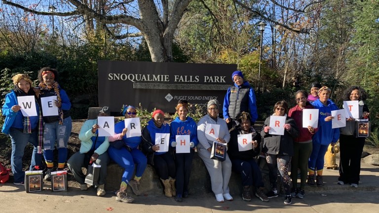 A group of women hold up letters to spell out "We are Harriet." 
