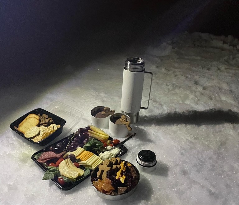 Charcuterie spread, cookies, hot chocolate and more on a snowshoe trip at Gold Creek Pond. Photo by Hiker Mama.