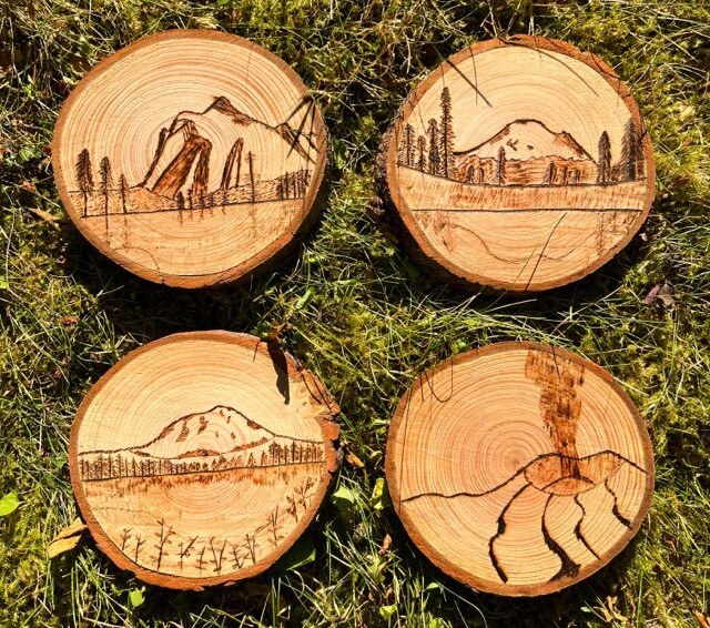 Wooden coasters, a cross-section of a branch with images of mountains. 
