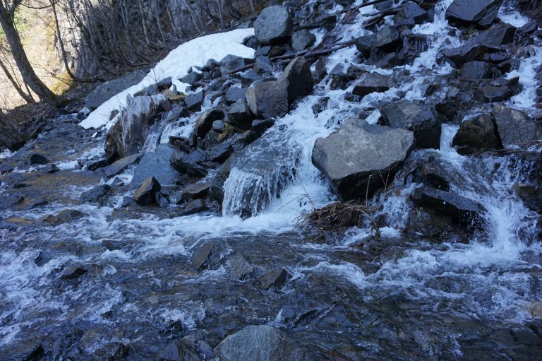A frozen creek crossing over the trail. 