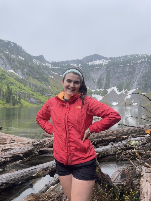 hiker standing in front of mountain backdrop