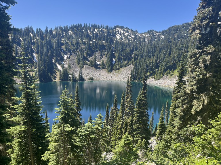 View of the lake from the Josephine Lake trail on a sunny clear day. Photo by norah.