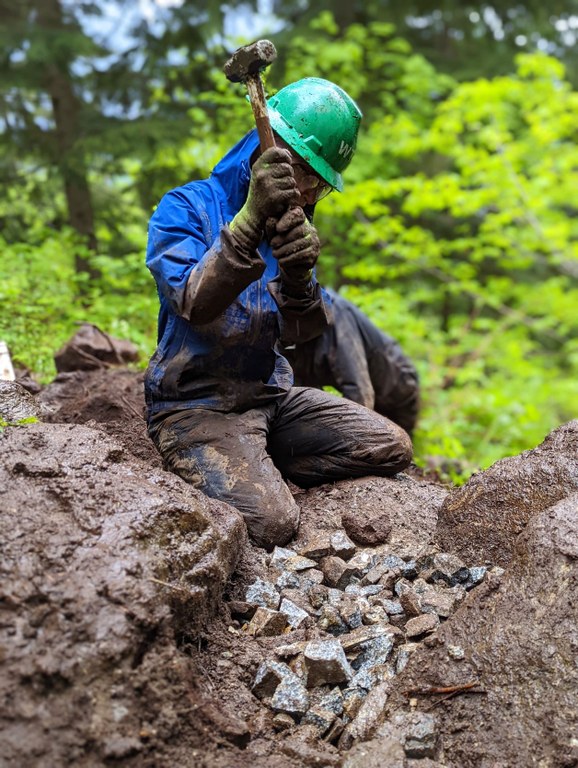 Breaking down rocks with a sledgehammer. Photo by Zachary Toliver. Breaking down rocks with a sledgehammer. Photo by Zachary Toliver.