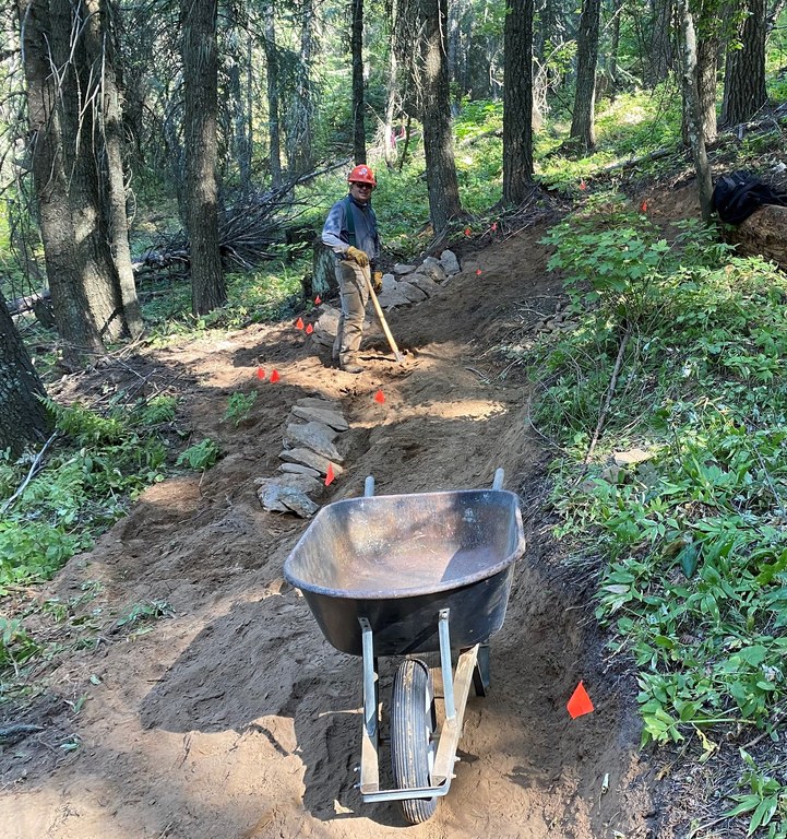 A WTA volunteer smiles on the new California Creek Connector Trail