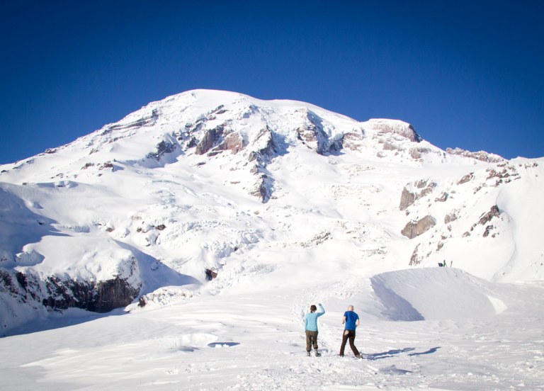 Two hikers on the snow at Paradise in Mount Rainier National Park. Photo by Julie Mahieu.