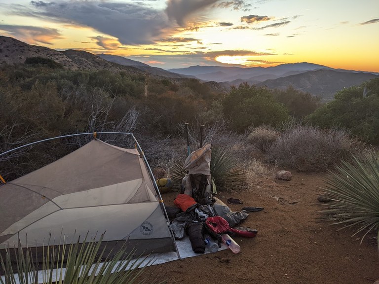 A tent, groundsheet and gear in the desert of Southern California.