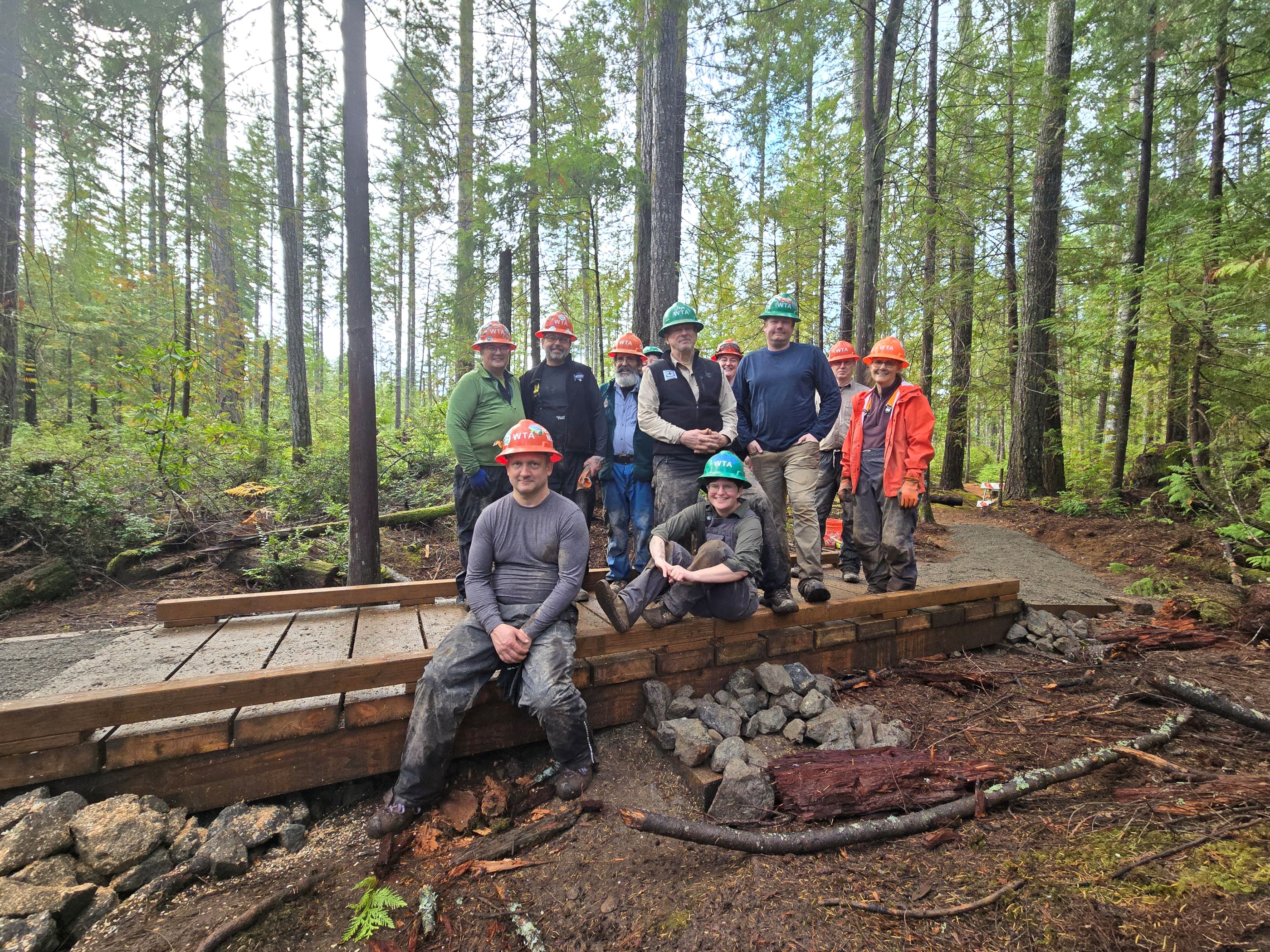 A new puncheon at Newberry Hill. Photo by Paul Boronow. A WTA trail crew poses, smiling, at a newly-built puncheon at Newberry Hill Heritage Park. Photo by crew leader Paul Boronow.