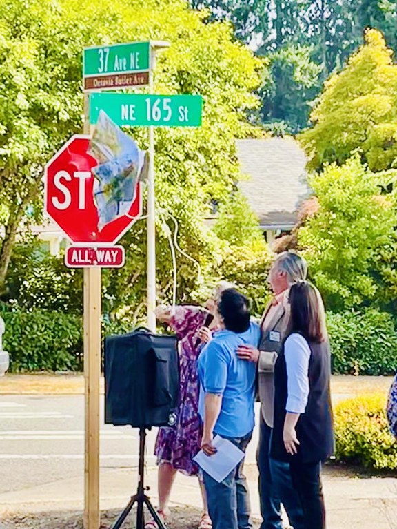 Four officials stand on a street corner in Seattle.