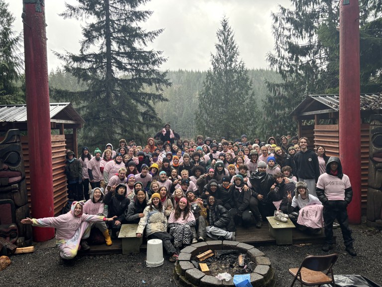 Post 84 A large group of high school students behind a campfire ring.