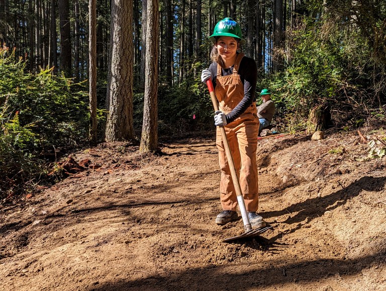 Volunteer at Vashon A volunteer poses on newly-built trail