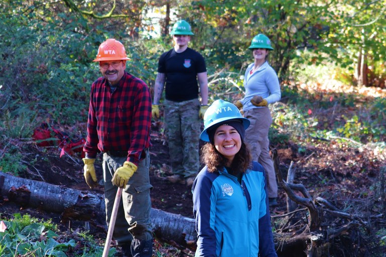A volunteer crew smiles at the camera during a day of work at Ridgefield. A volunteer crew smiles at the camera during a day of work at Ridgefield.