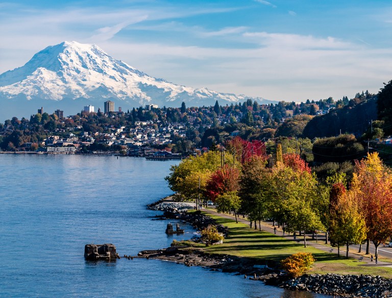 A tree-lined trail in Tacoma with Mount Rainier in the background.