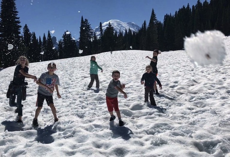 Five children throw snowballs toward the camera. Photo by Malissa Waterford. 