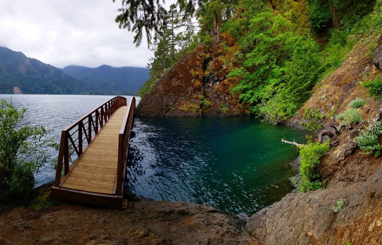 A bridge crosses over an aquamarine inlet on the shore of Lake Crescent. Photo by Marissa Edwards. 