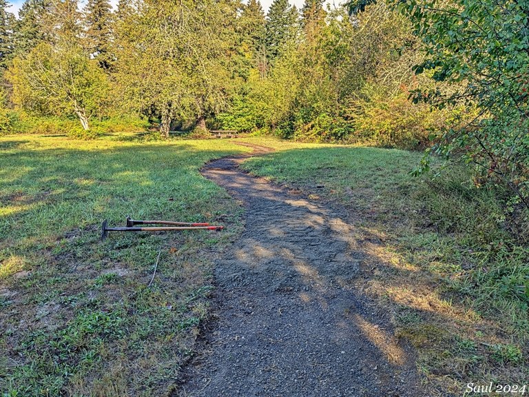 A couple of trail work tools on the ground on a trail work party at St. Cloud. Photo by Sunrise Creek.