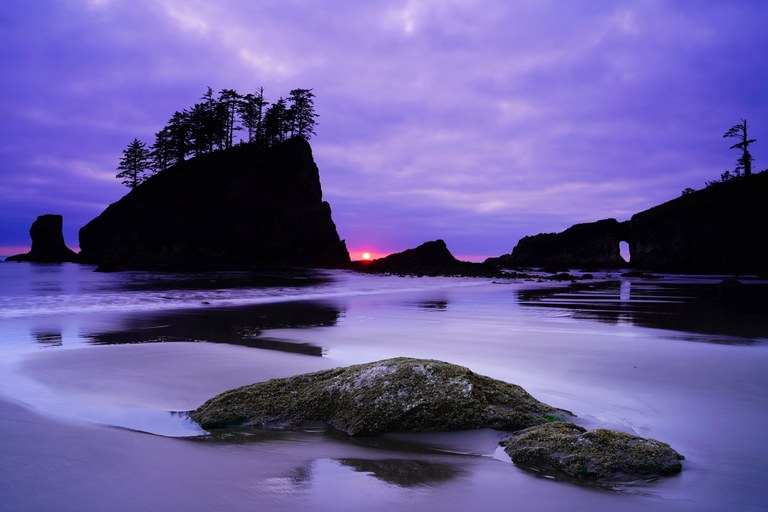 3rd Place Trailscapes Rocks in ocean at beach during twilight