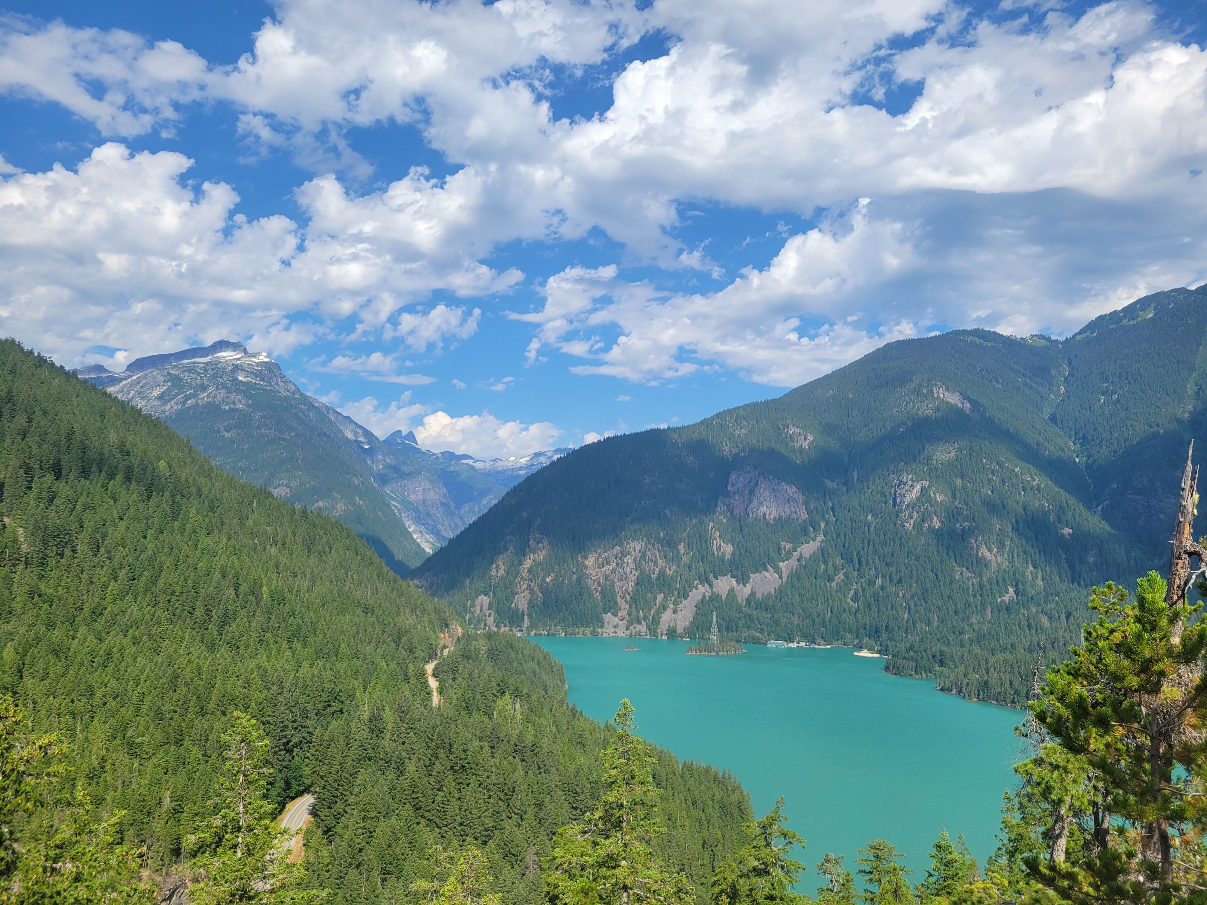 View of a bright teal Diablo Lake from the Thunder Knob trail on a sunny day. Photo by WildMountainMama. 