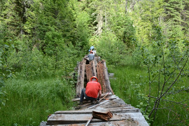 North Fork Sullivan trail volunteers dismantle a bridge. Photo by Loren Drummond.