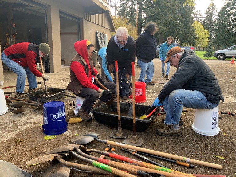 Crew members at a tool maintenance party washing and maintaining WTA tools in the springtime. Photo by Stasia Honnold.