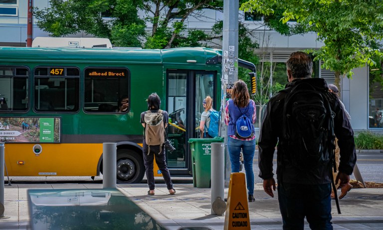 Trailhead Direct riders getting onto a bus at a King County Metro stop in Seattle