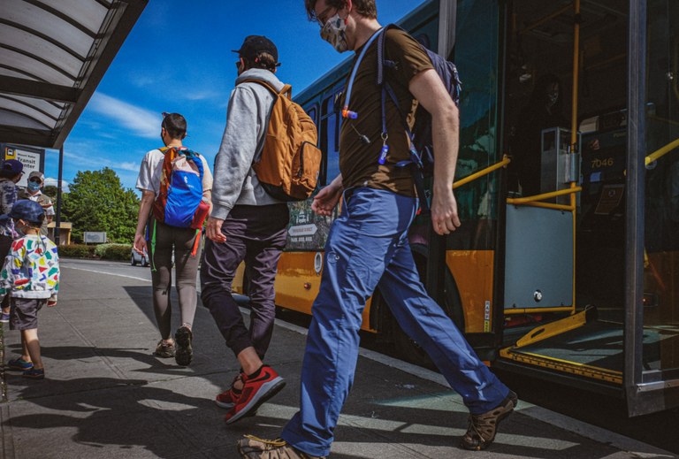 Trailhead Direct riders get off a bus after taking the bus to and from a trailhead