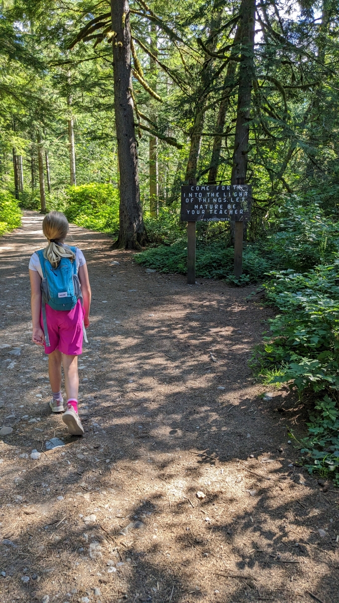 Wallace Falls. Photo by karacmomof3. A young hiker walks past the Wordsworth quote sign at Wallace Falls. Photo by karacmomof3.