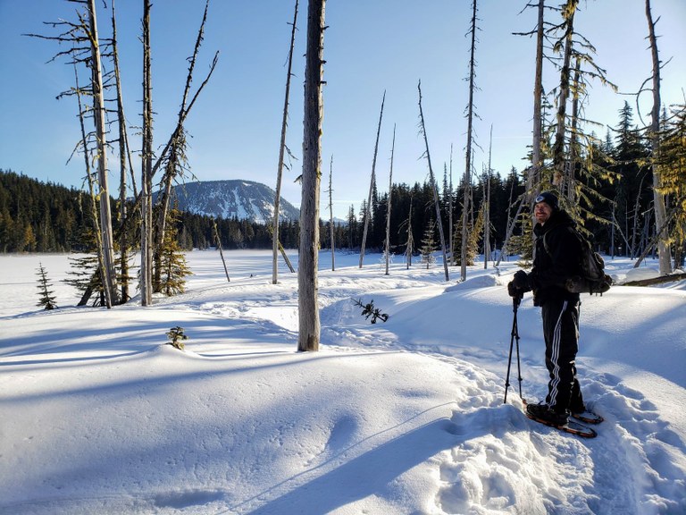 A hiker snowshoeing on the trail at the White Pass Nordic Center. Photo by AllOfUs.