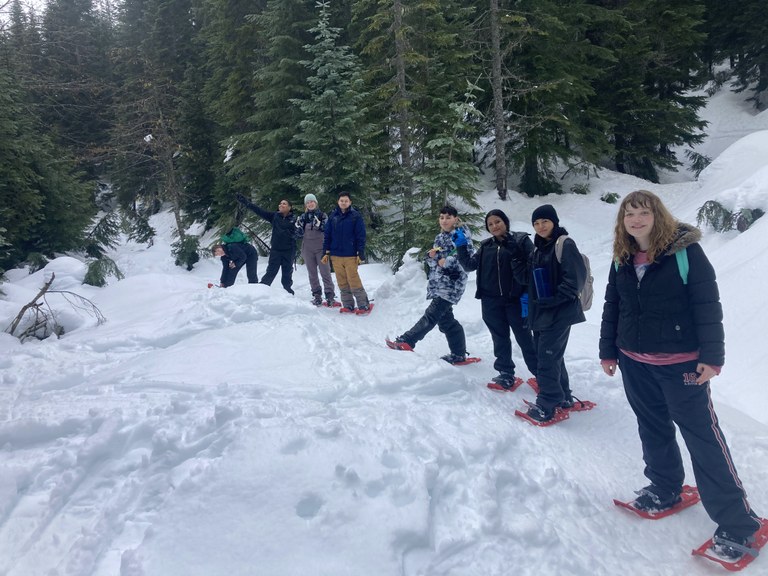 Y.E.T.I. Youth on a snowshoeing trip in the woods.