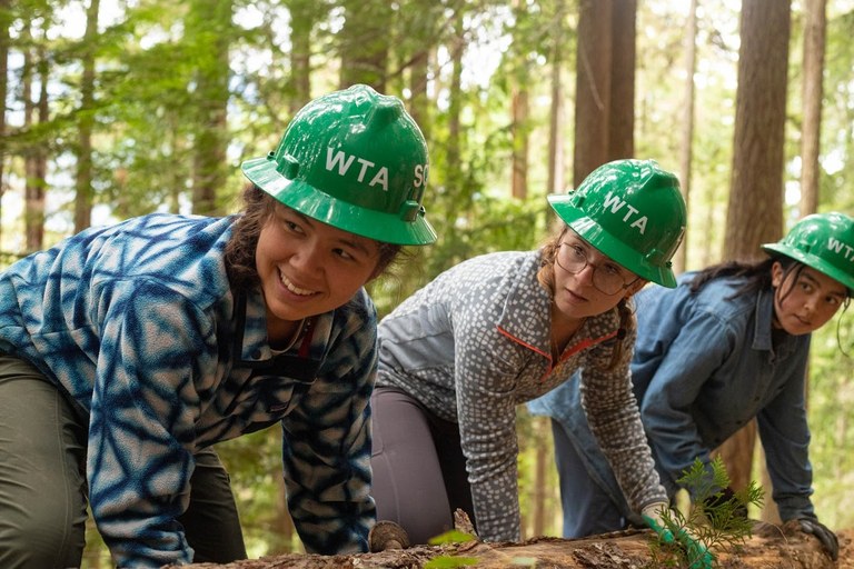 Photo by Kesia Lee Women wearing hard hats in a forest.