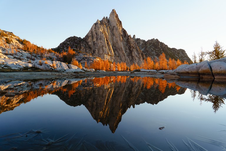 Still Sprite Lake and dramatic Little Annapurna peak are photographed against a calm fall sky.