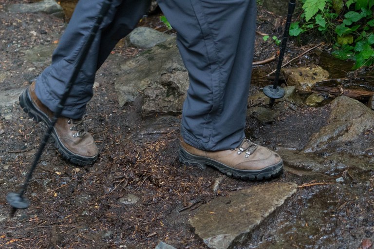 Boots hiking along a wet trail Boots hiking along a wet trail