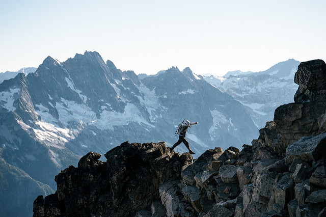 A climber boulder hopping up to Black Peak. Photo by Sammy Davis
