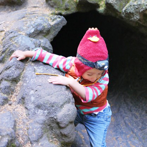 Lola climbs on rocks in September at Trail of Two Forests. Photo by Ryan Ojerio. 
