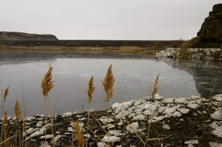 A river under a cloudy sky provides a quiet landscape to meditate in