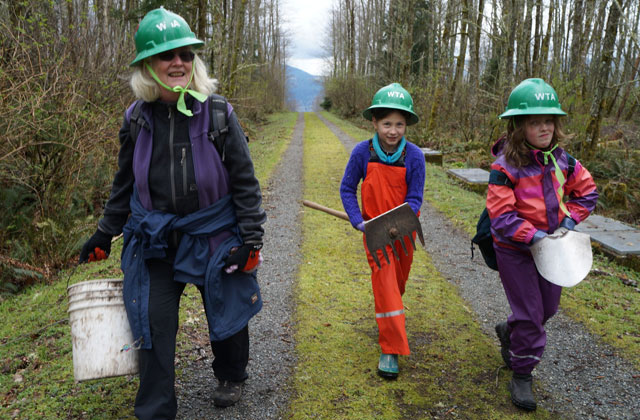 Girls hiking in on WTA work party Heidi Watters Moods may change from morning to afternoon on a volunteer trip. Photo courtesy Heidi Watters.