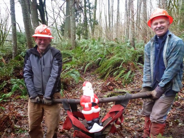 Supervising is hard work! Volunteers John and Frank give Santa a lift (along with some rocks) at Larrabee State Park. Photo by Jon Nishimura.