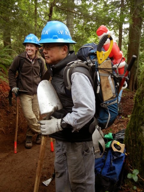 Dedicated volunteer Jon Nishimura plays the part of reindeer, hauling Santa into the work site. Photo by Julie Cassata.
