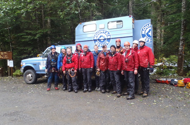 Seattle Mountain Rescue poses for a photo after a long day of training in the rain and sleet before going out for dinner en masse in North Bend.