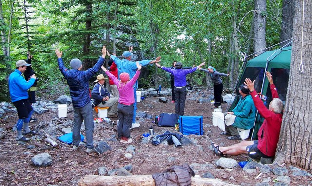 Stretching before a day of trail work is an important part of a volunteer vacation. Photo by Kathy Bogaards. 