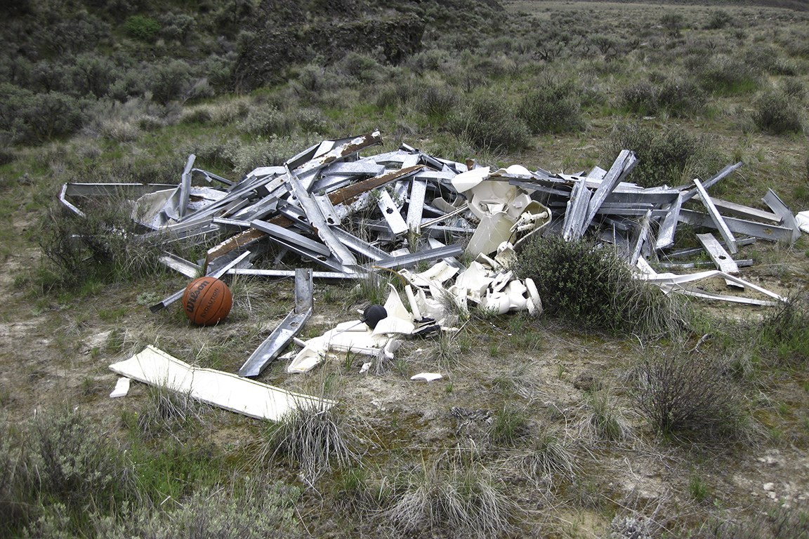 One of many trash-heaps along the way, including toilets, aluminum gutters and siding, and a perfectly good basketball