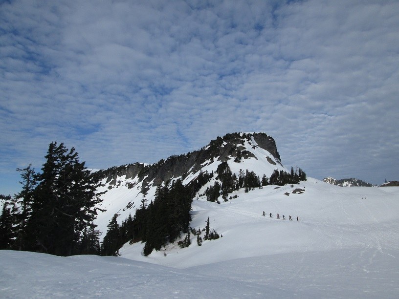 skiers heading past table mountain to the deep backcountry bowls