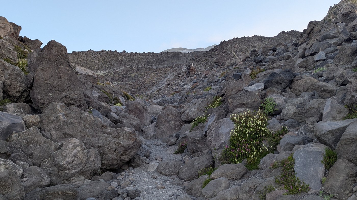 Looking up the boulder field.  Look carefully and you will see white poles along the ridge at the right marking the route.  But the going is easier in the lower ground paralleling the ridge on the left.